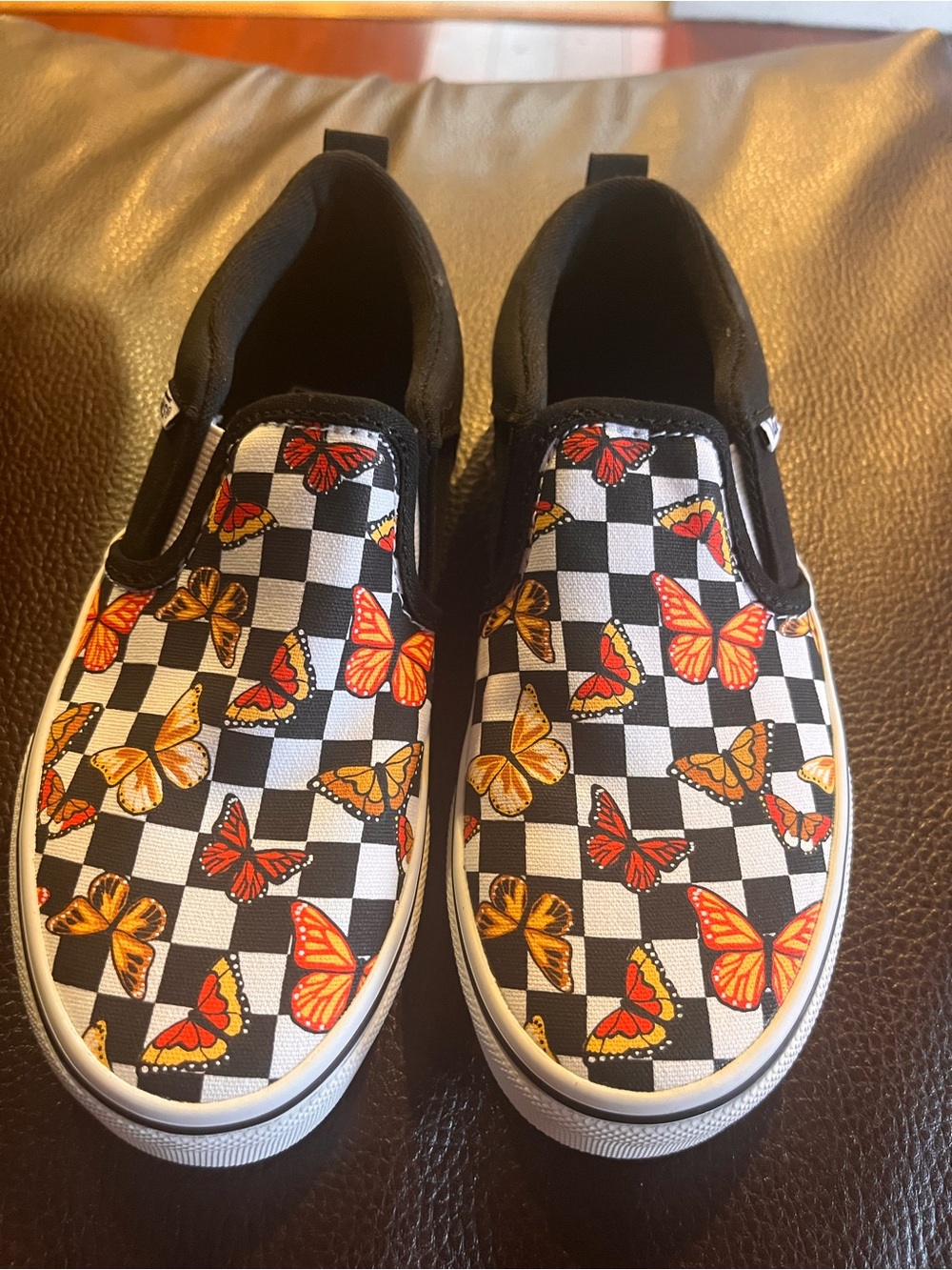 Vans Kids Slip-On Checkerboard Sneakers with Orange Butterflies